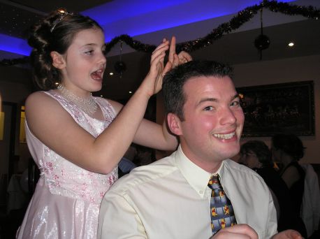 Lizzie drumming her fingers on James' spiky haircut