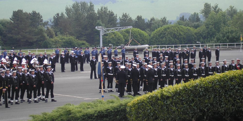 The division stands to attention while the officers inspect each man in turn.