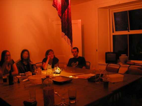 A red shawl draped over the bare fluorescent bulb.